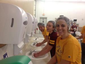 NCF members wash their hands before packaging food for Feed My Starving Children, a nonprofit organization. Photo courtesy of Nurses Christian Fellowship.